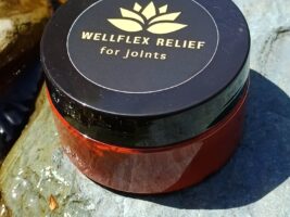 Pot of Wellflex Relief from Wellspring Company for joints placed on rock in stream.